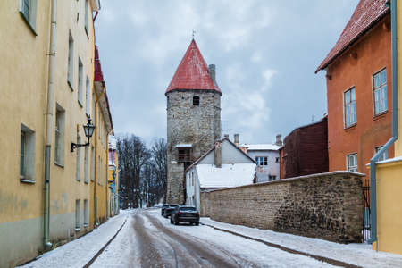 Tallinn, Estonia - December 25, 2018: Perspective view of apartment buildings and the Plate Tower on the Suurtuki Street in the Tallinn Old Town in overcast winter dayのeditorial素材