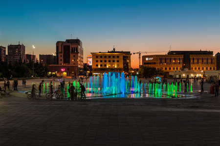 Tyumen, Russia - May 21, 2021: Beautiful view of the dancing fountain during the musical light show on the Square of the 400th Anniversary of Tyumen on the background of illuminated buildings at twilightのeditorial素材
