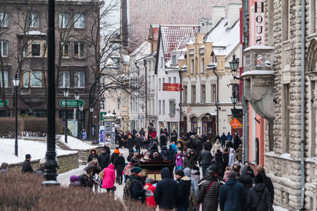 Tallinn, Estonia - December 25, 2018: Perspective view of the Harju Street with a crowd of walking people in the Tallinn Old Town in overcast winter dayのeditorial素材