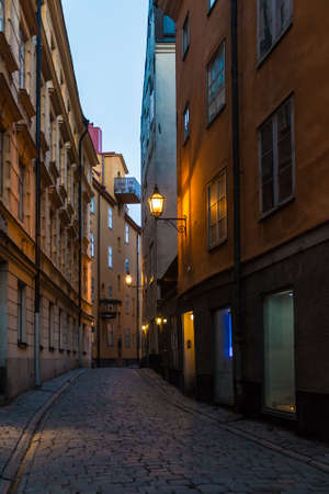 Perspective view of historical buildings on the Tyska Skolgrand Alley at twilight, Stockholm, Swedenの写真素材