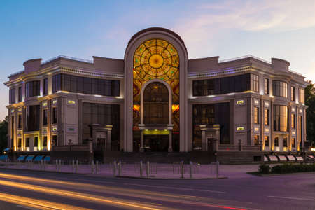 Beautiful front view of the illuminated Wedding Palace on the Malygina Street in summer day at twilight, Tyumen, Russiaのeditorial素材