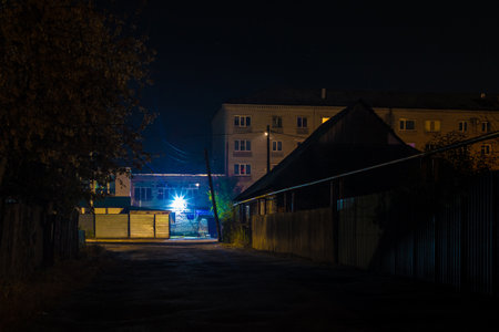 Perspective view of the illuminated Telmana Street in autumn at night, Kurgan, Russiaの写真素材