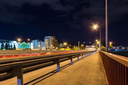 Beautiful perspective view of the illuminated Chelyuskintsev Bridge at dusk, Tyumen, Russiaの写真素材