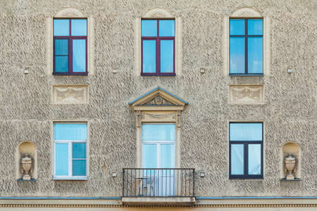 Balcony and several windows in a row on the facade of the urban historic apartment building front view, Saint Petersburg, Russiaの写真素材