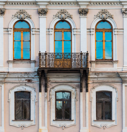 Balcony and several windows in a row on the facade of the urban historic apartment building front view, Saint Petersburg, Russiaの素材 [FY310185046349]