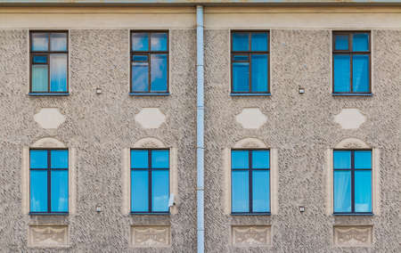 Several windows in a row on the facade of the urban historic apartment building front view, Saint Petersburg, Russiaの写真素材