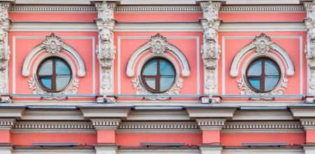 Three windows in a row on the facade of the urban historic apartment building front view, Saint Petersburg, Russiaの写真素材