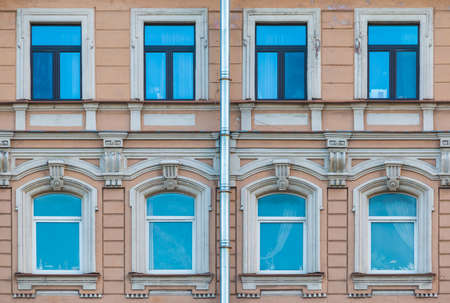 Several windows in a row on the facade of the urban historic apartment building front view, Saint Petersburg, Russiaの写真素材