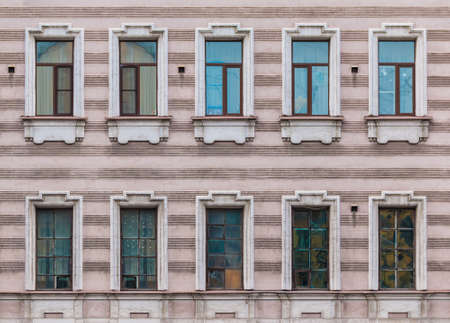 Many windows in a row on the facade of the urban historic apartment building front view, Saint Petersburg, Russiaの写真素材