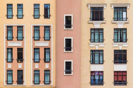 Many windows in a row on the facade of the modern urban apartment building front view, Krasnaya Polyana, Sochi, Krasnodar Krai, Russiaの写真素材