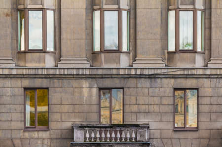 Balcony and several windows in a row on the facade of the urban historic apartment building front view, Saint Petersburg, Russiaの写真素材