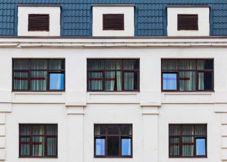 Several windows in a row on the facade of the modern urban apartment building front view, Krasnaya...