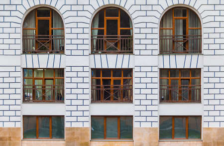 Several windows in a row on the facade of the modern urban apartment building front view, Krasnaya Polyana, Sochi, Krasnodar Krai, Russiaの写真素材
