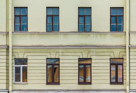 Several windows in a row on the facade of the urban historic apartment building front view, Saint Petersburg, Russiaの写真素材