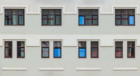 Many windows in a row on the facade of the modern urban apartment building front view, Krasnaya Polyana, Sochi, Krasnodar Krai, Russiaの写真素材
