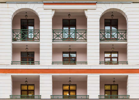 Several balconies and windows in a row on the facade of the modern urban apartment building front view, Krasnaya Polyana, Sochi, Krasnodar Krai, Russiaの写真素材