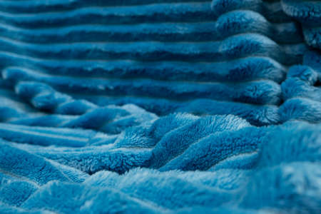 Blurred blue blanket background. Crumpled terry bedspreadの写真素材
