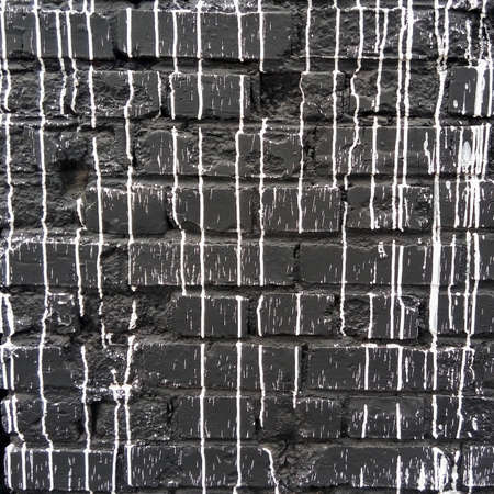 Background of white and black brick wall pattern texture. Paint on the wall. Streaks of paint.の写真素材