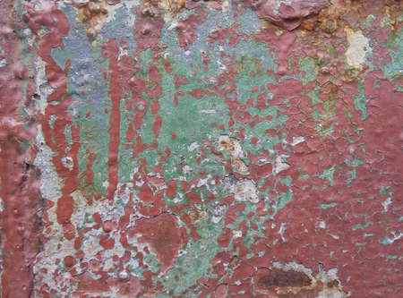 Textured old metal sheet with peeling paint and a little rust.の写真素材