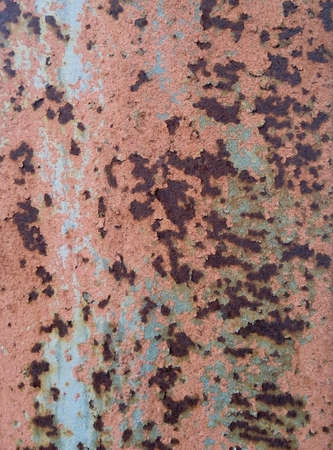 Textured old metal sheet with peeling paint and a little rust.の写真素材