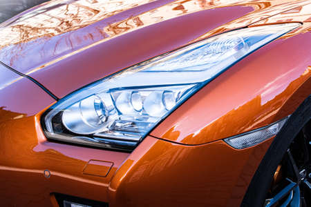St. Petersburg, Russia, 05/03/2021: headlight car close up Nissan GT-R generation R35 restyling in the street parking. Nissan GTR in town.のeditorial素材