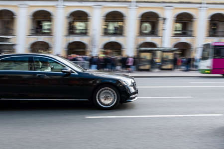 St. Petersburg, Russia, 05/03/2021: Black car on the street road. Black mercedes. Blurred...