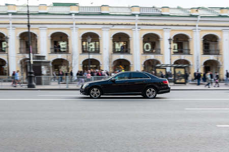 St. Petersburg, Russia, 05/03/2021: Black car on the street road. Black mercedes. Blurred background. Car motion.のeditorial素材