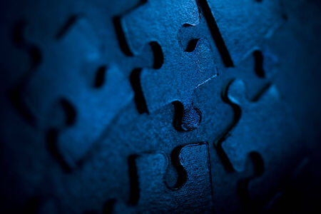 Neon blue jigsaw parts on dark background. Puzzle conceptの写真素材