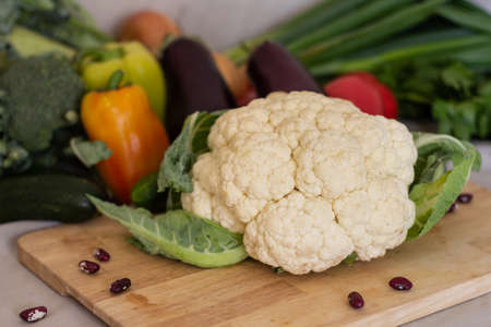 delicious fresh white cauliflower on a beautiful blurry vegetables backgroundの写真素材