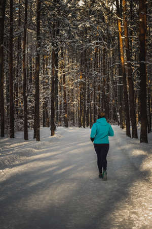 Running on the road in the winter forestの写真素材