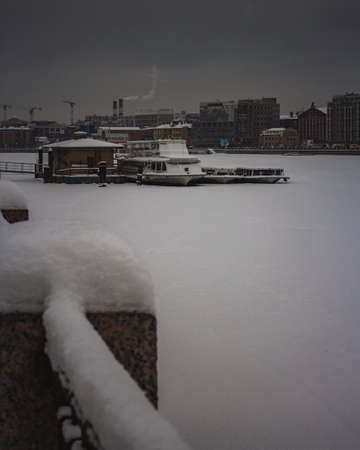 River boats in the frozen river neva in winterの写真素材