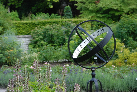 Sundial on the flowerbed in the parkの写真素材