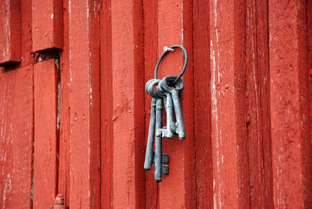 Old keys on red wooden wallの写真素材