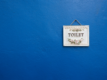 Toilet sign hang at the blue wallの写真素材