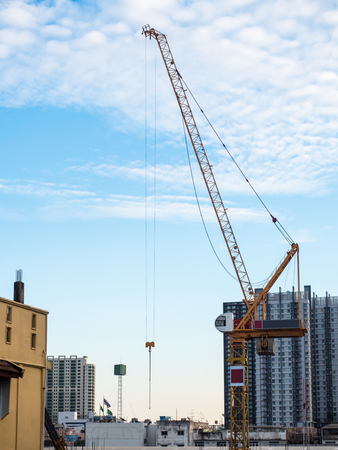 Crane and construction building. Construction crane and the building against the sky background.の写真素材