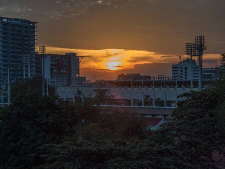 The Sun is moving down in the center of Bangkokの写真素材