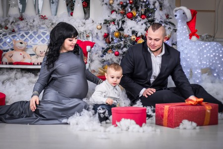 Happy family of Christmas open gift.