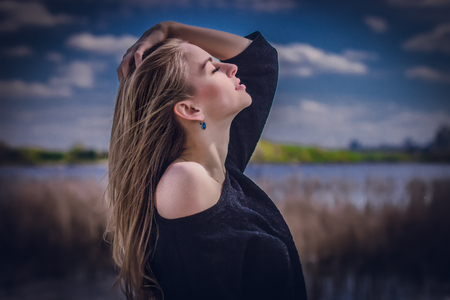 Beautiful girl in profile against the background of the Lake.のeditorial素材