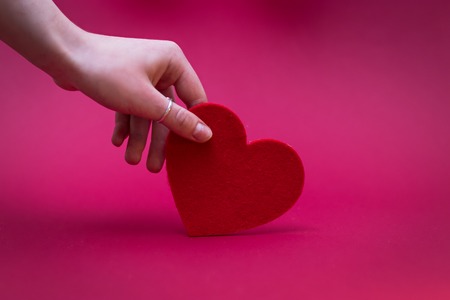Valentines Day. Love heart. Female hands holding red heart.の写真素材