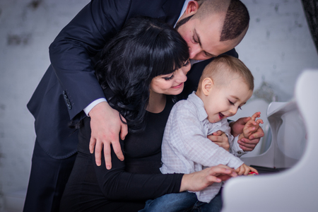 the child plays the piano for mom and dad.の写真素材