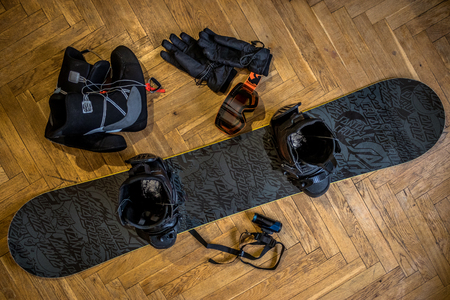 Snowboarder equipment on the wooden floor.の写真素材