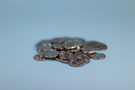 a handful of coins on a blue background.の写真素材