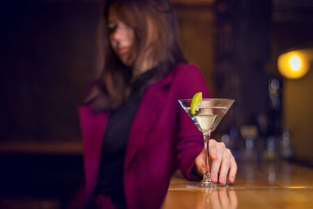 Beautiful girl drinks a cocktail at the barの写真素材