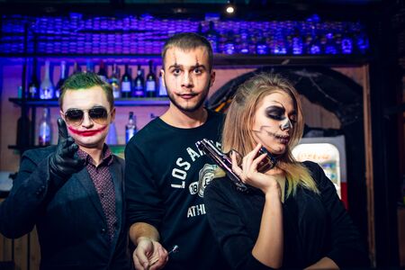 Male and female face art for halloween in bar.のeditorial素材