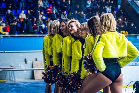 Kiev, Ukraine - December 17, 2019: ice hockey u20 world championship Ukraine - Ukraine VS Italy Group of cheerleaders in action with male coachのeditorial素材