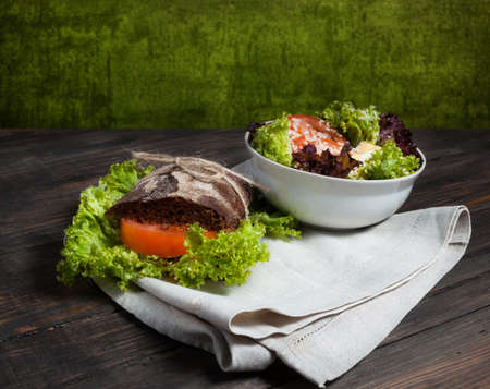 Grain bread sandwiches and fresh vegetables on wood - healthy eating conceptの写真素材