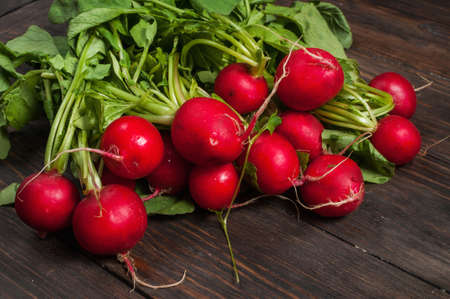 Fresh radish on old wooden table. Radish background. Rustic Style.の写真素材
