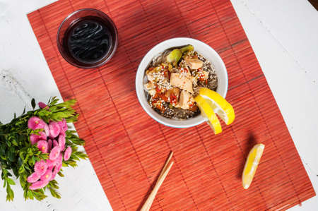 Cooked funchoza with chicken fillet and toasted sesame seeds.