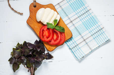 Mozarella cheese with tomatos and basil. Close upの写真素材