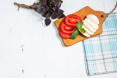 Mozarella cheese with tomatos and basil. Close upの写真素材